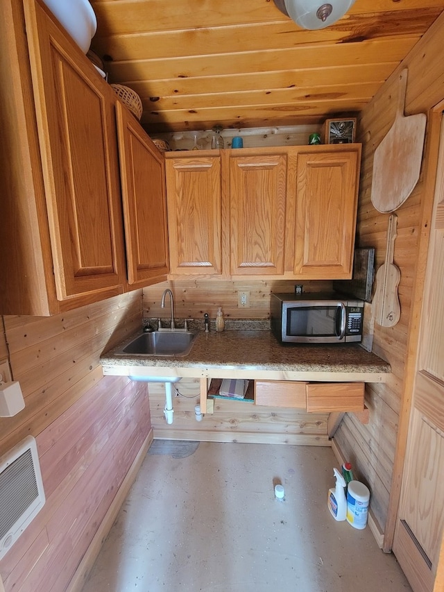 kitchen with sink and wood walls