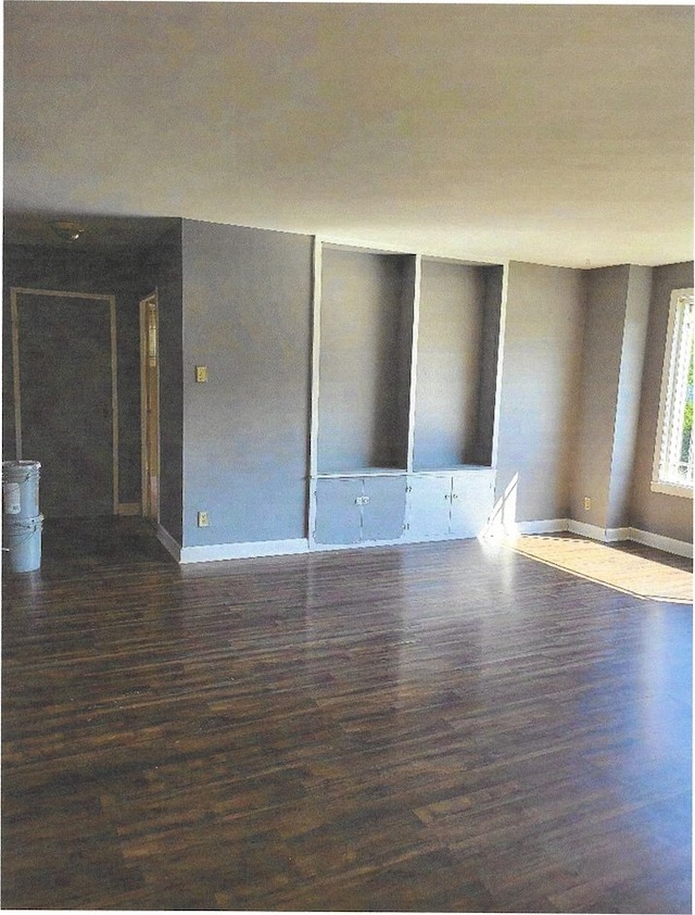 empty room with dark hardwood / wood-style floors