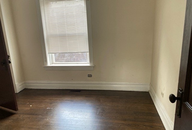 spare room with dark hardwood / wood-style floors