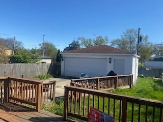 deck featuring an outdoor structure and a garage