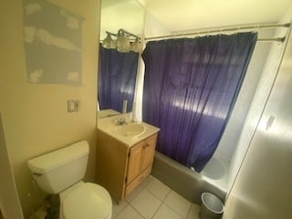 full bathroom with shower / bath combo, toilet, tile floors, and vanity