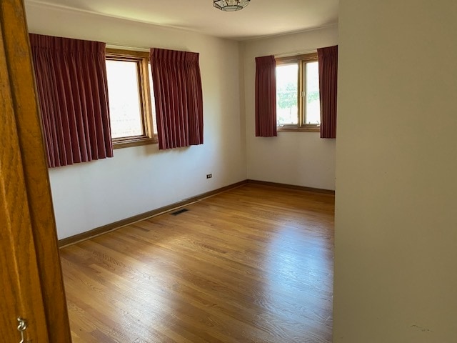 empty room with wood-type flooring