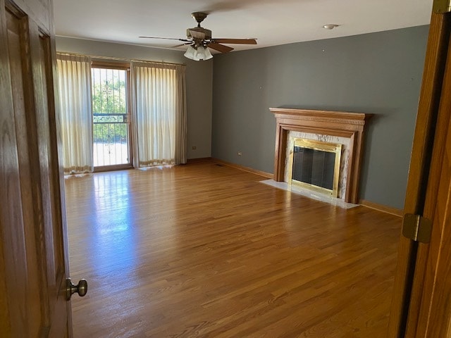 unfurnished living room featuring hardwood / wood-style floors and ceiling fan