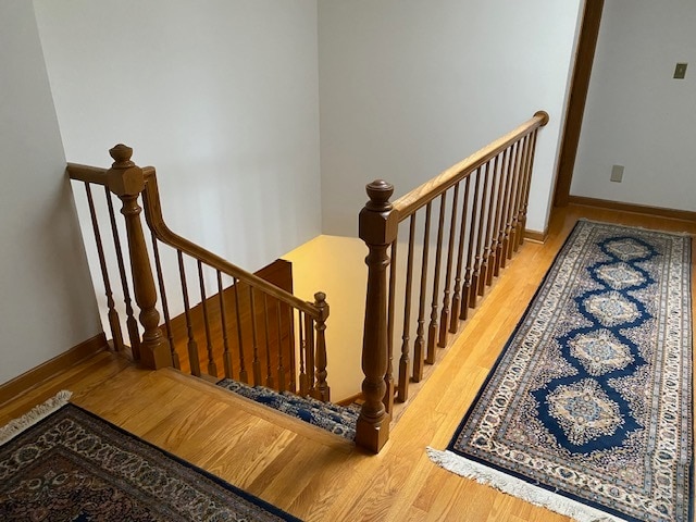 stairs with hardwood / wood-style flooring