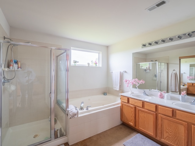 bathroom featuring vanity with extensive cabinet space, double sink, and plus walk in shower