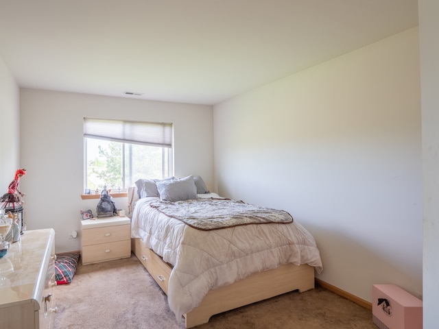 bedroom featuring light colored carpet