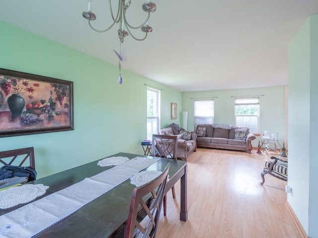 dining room featuring hardwood / wood-style flooring and a chandelier