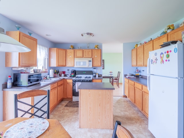 kitchen featuring sink, white appliances, a center island, and light tile floors