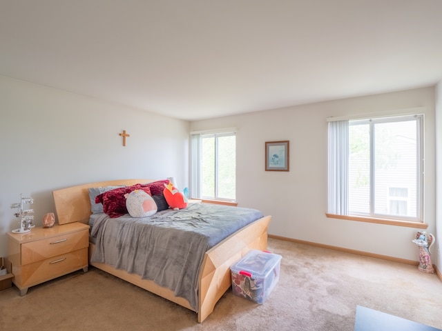 carpeted bedroom with multiple windows