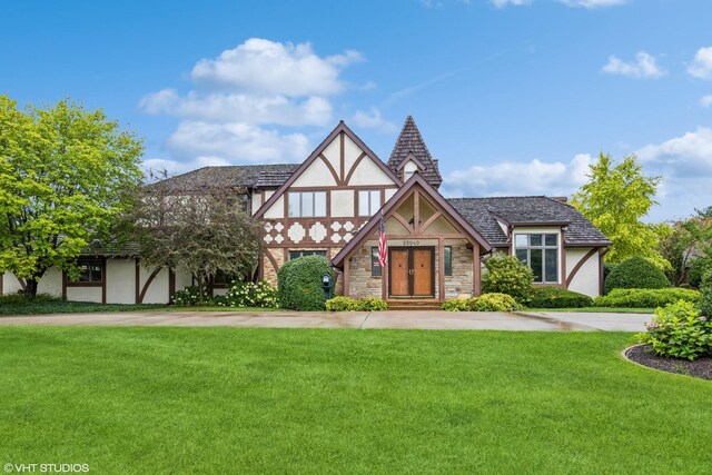 tudor home with a front yard