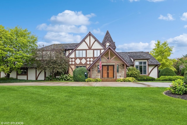 tudor house featuring a front yard