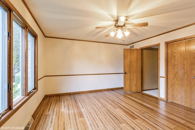 spare room featuring crown molding, ceiling fan, and light hardwood / wood-style floors