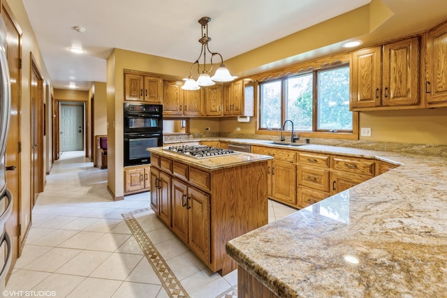 kitchen featuring sink, stainless steel gas cooktop, decorative light fixtures, a kitchen island, and black double oven