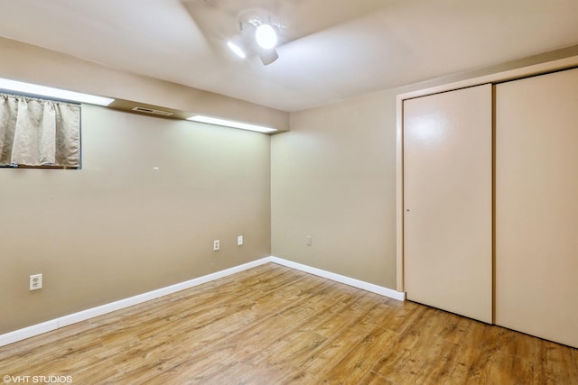 basement with light hardwood / wood-style flooring