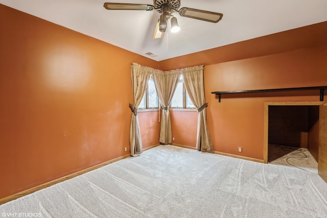 unfurnished room featuring light carpet and ceiling fan