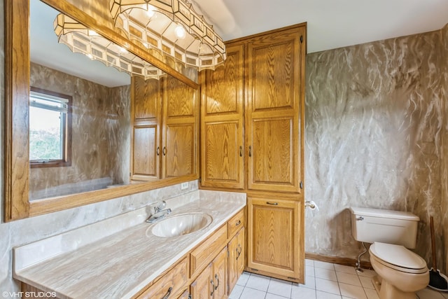 bathroom featuring vanity, tile patterned floors, and toilet