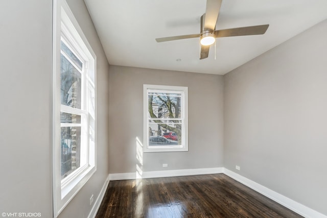 empty room featuring dark wood-type flooring and ceiling fan