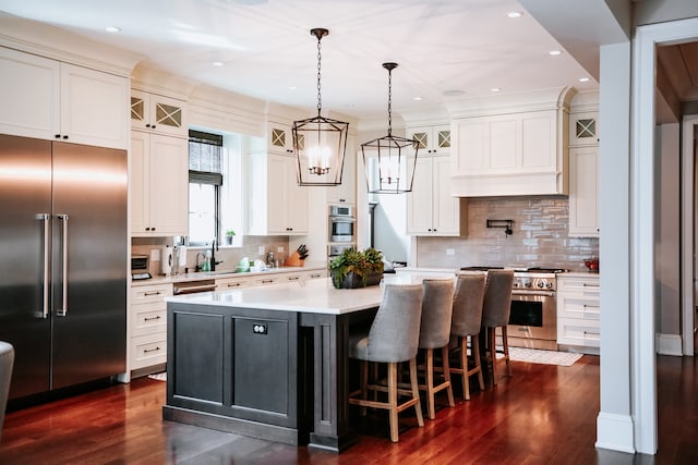 kitchen featuring a center island, hanging light fixtures, dark hardwood / wood-style floors, backsplash, and high quality appliances