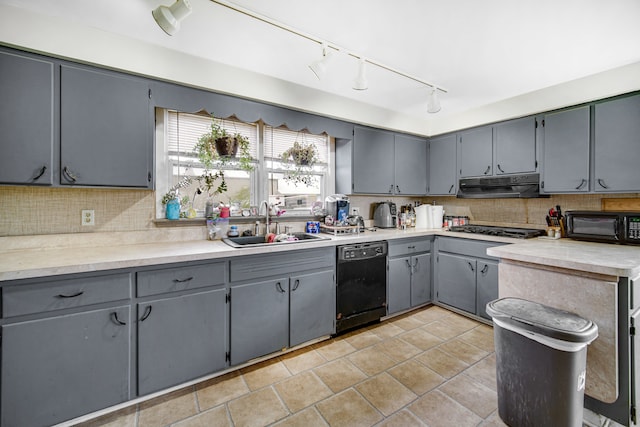 kitchen with sink, fume extractor, backsplash, rail lighting, and black appliances