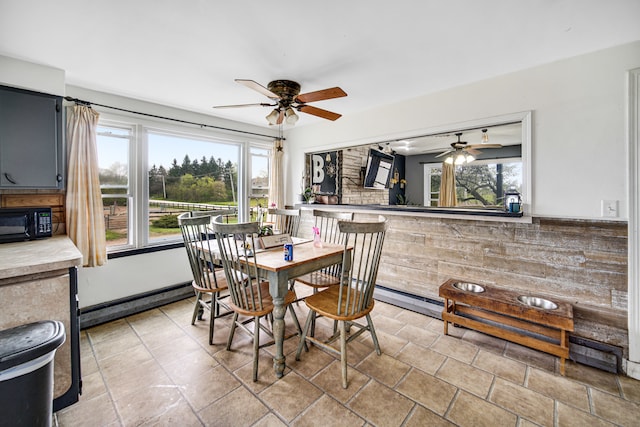 dining space with ceiling fan, light tile floors, and a wealth of natural light