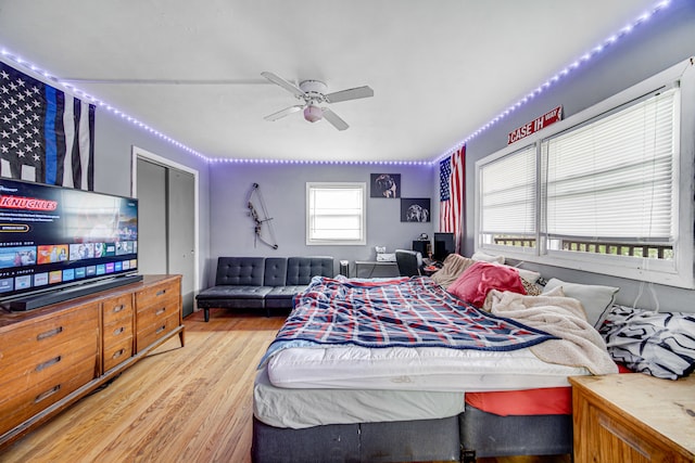 bedroom with a closet, ceiling fan, and light wood-type flooring