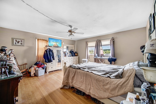 bedroom featuring light hardwood / wood-style flooring and ceiling fan