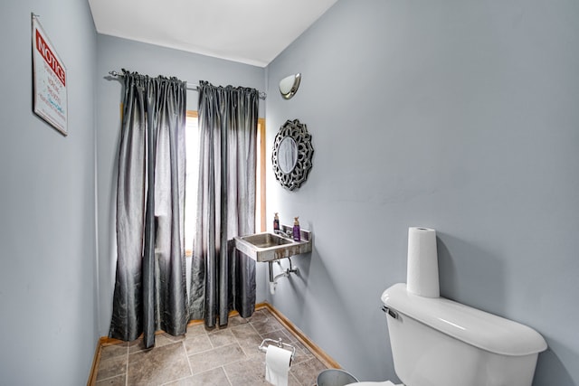 bathroom featuring toilet and tile flooring