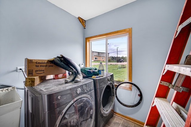 clothes washing area featuring tile flooring, sink, and washer and clothes dryer