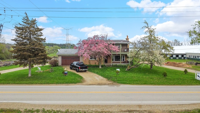 view of front of property with a garage and a front yard