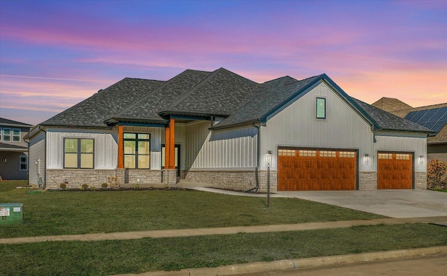 view of front of property featuring a yard and a garage