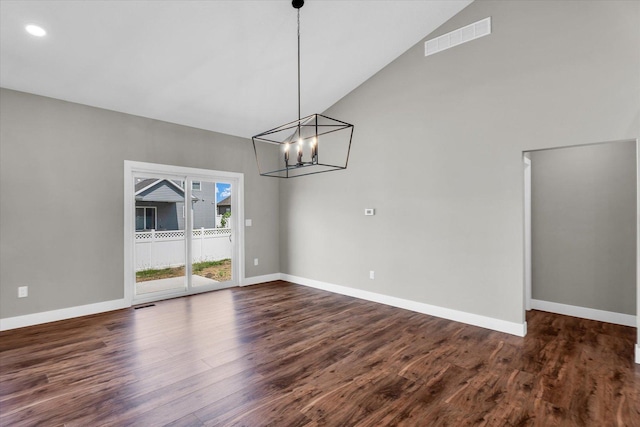 unfurnished dining area with high vaulted ceiling, a notable chandelier, and dark hardwood / wood-style floors