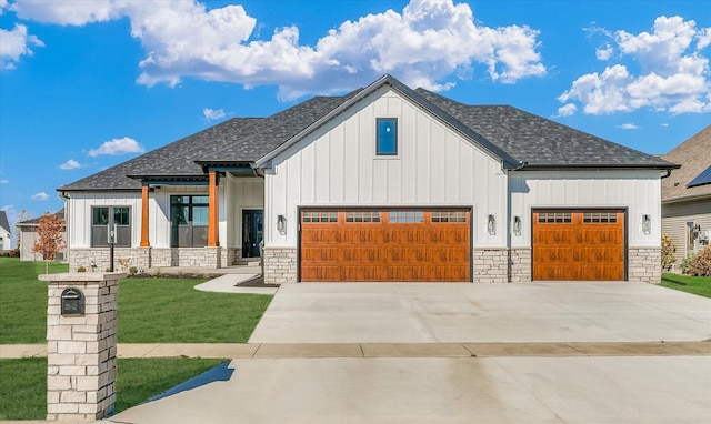 view of front of property with a front lawn and a garage