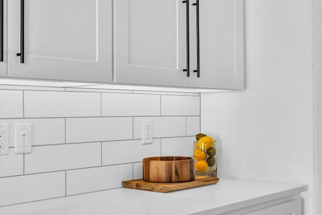 details with white cabinets and backsplash