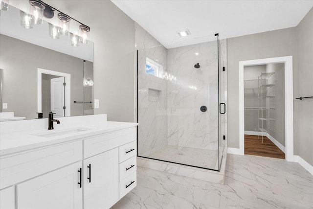 bathroom featuring an enclosed shower and vanity