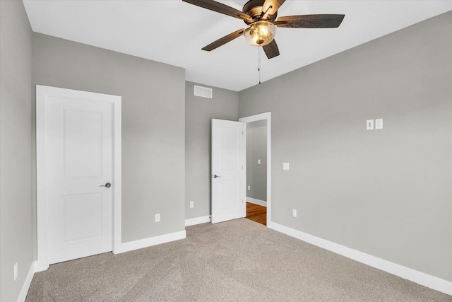 unfurnished bedroom with ceiling fan and carpet floors