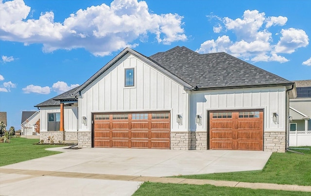 view of front of property featuring a garage and a front lawn