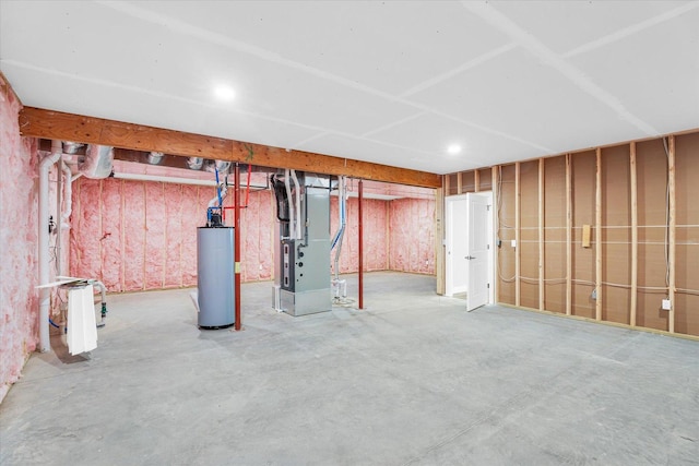 basement featuring water heater and heating unit