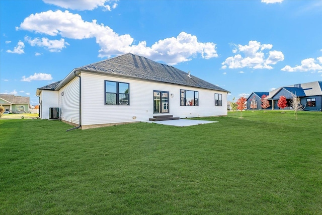 rear view of house featuring central air condition unit, a yard, and a patio