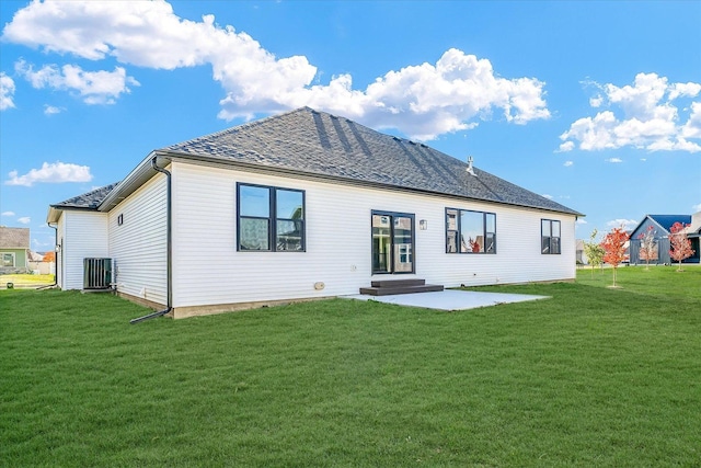 back of house featuring a yard, central AC unit, and a patio area