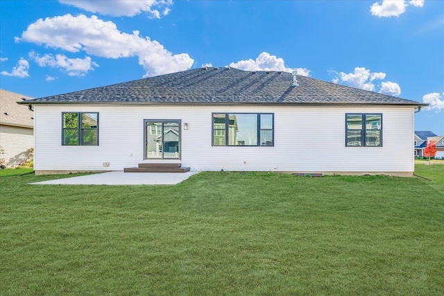 rear view of house with a lawn and a patio area