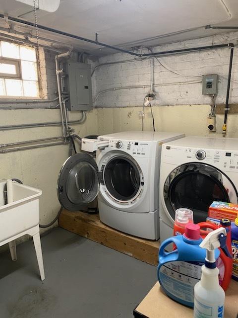 washroom featuring washing machine and dryer and electric panel