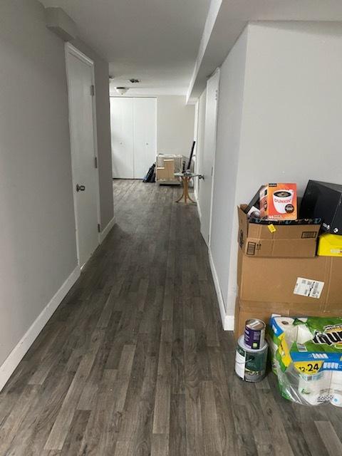 corridor with dark wood-type flooring