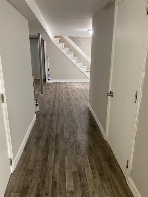 corridor with dark hardwood / wood-style flooring