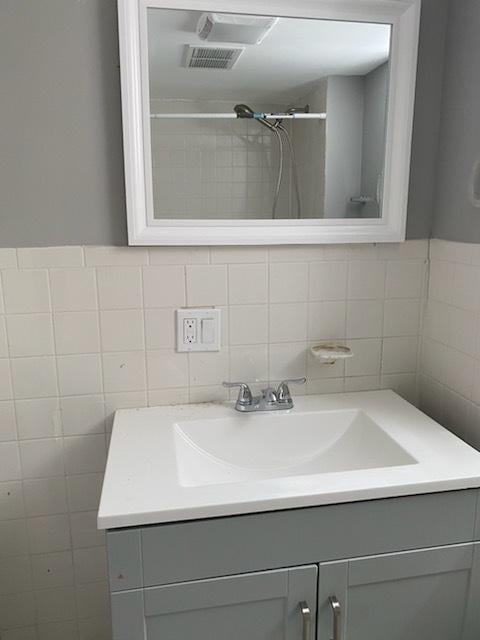 bathroom with vanity and walk in shower