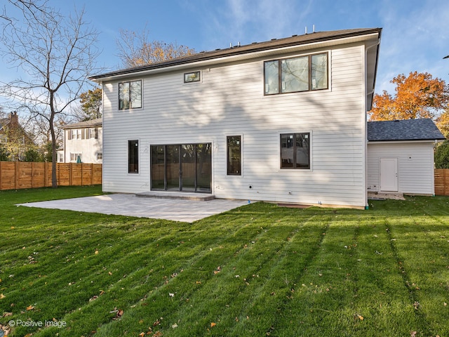 rear view of house with a lawn and a patio area