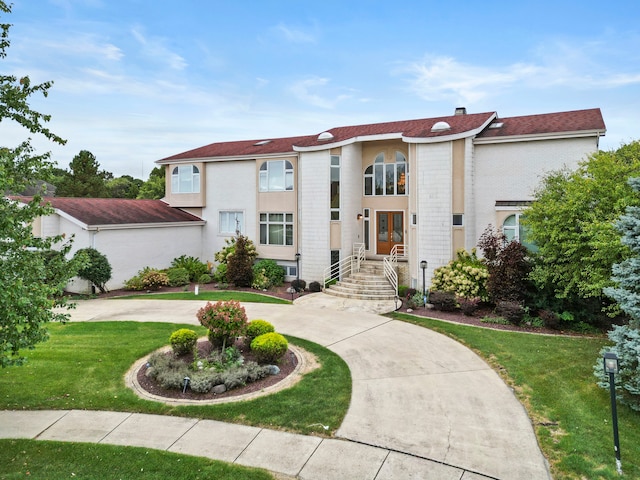 mediterranean / spanish house with a front lawn