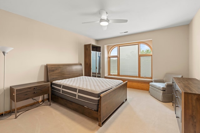 bedroom featuring ceiling fan and light carpet