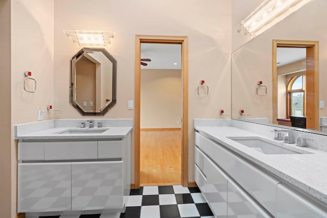 bathroom with wood-type flooring, ceiling fan, and vanity