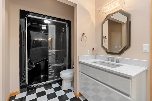 bathroom featuring a shower, vanity, and toilet