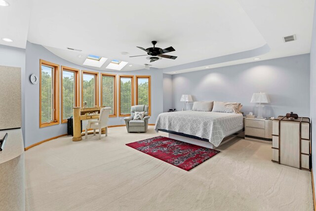 carpeted bedroom with ceiling fan and multiple windows